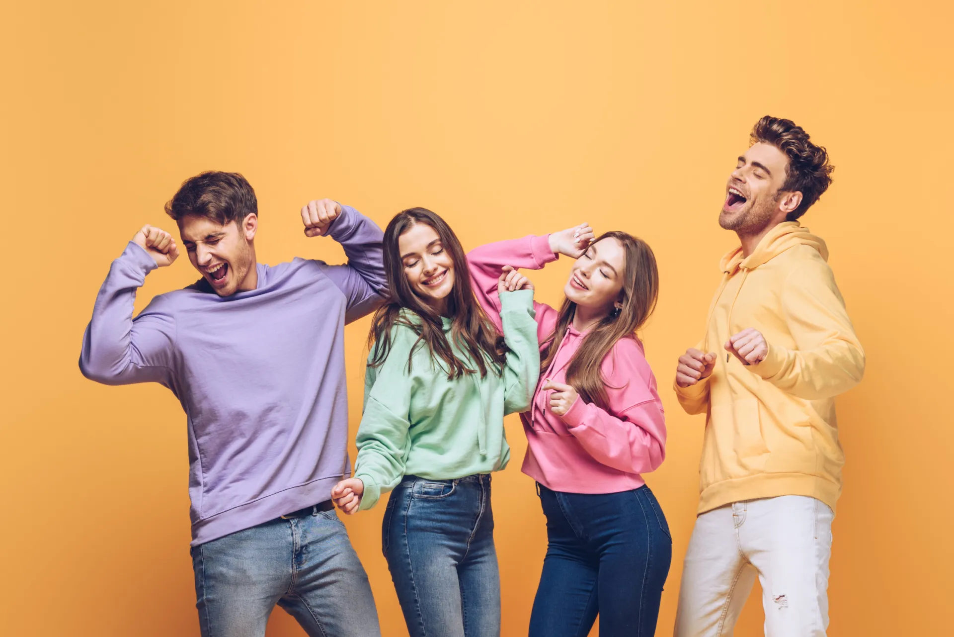 34780698 happy friends dancing together isolated on yellow