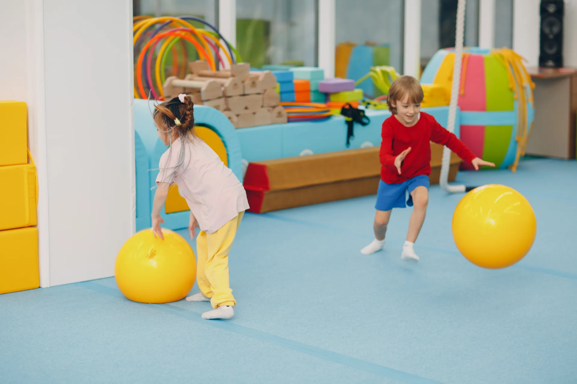 47038980 kids doing exercises with big ball in gym at