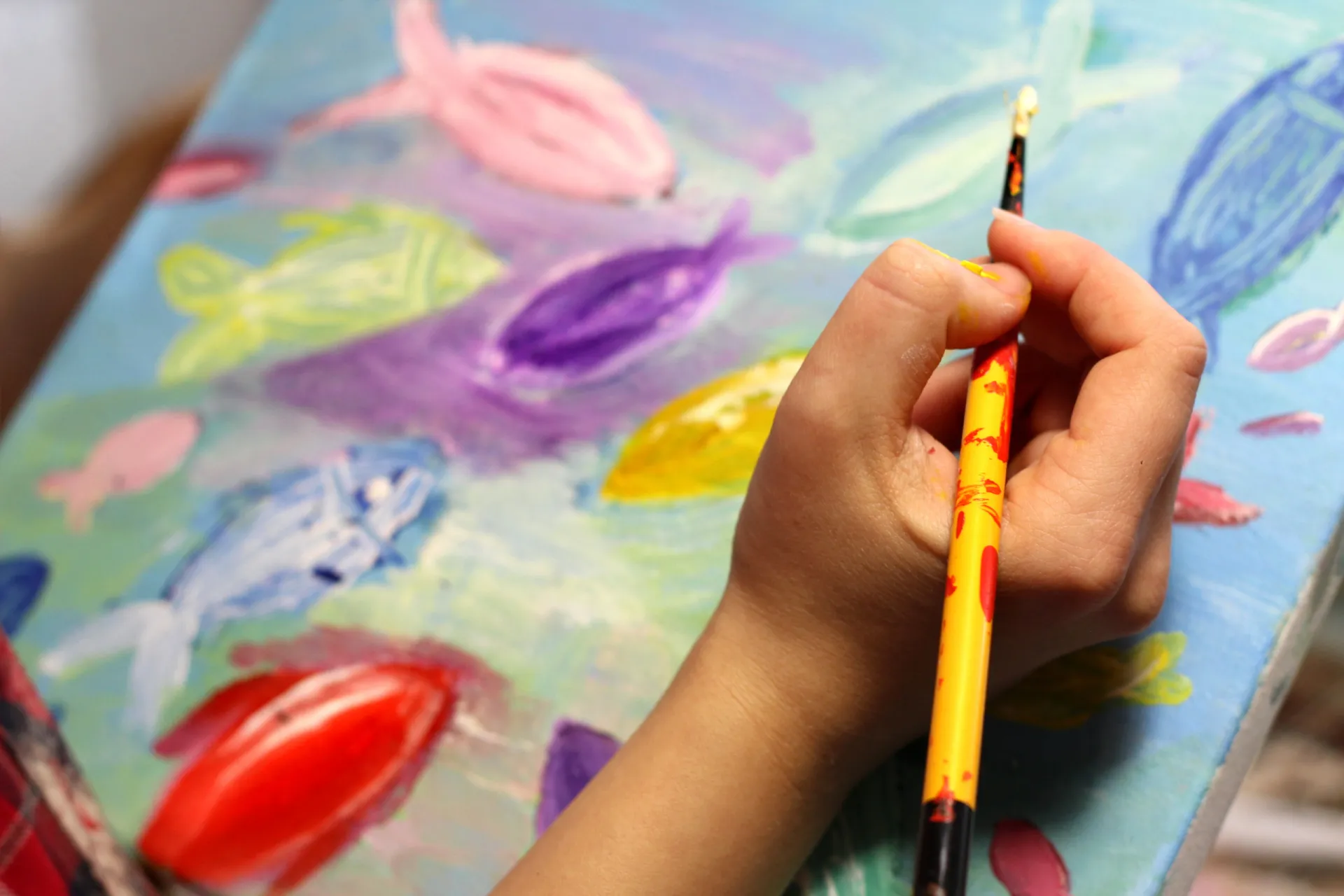 6819353 artist s hand with paintbrush painting the picture