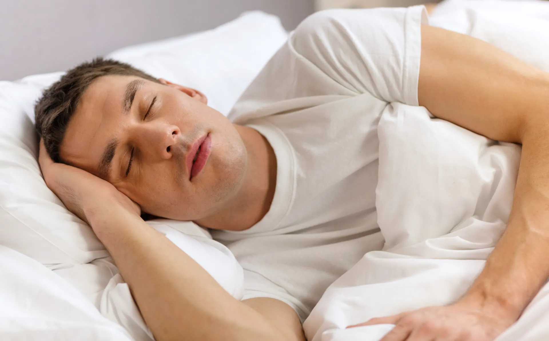 7642315 handsome man sleeping in bed
