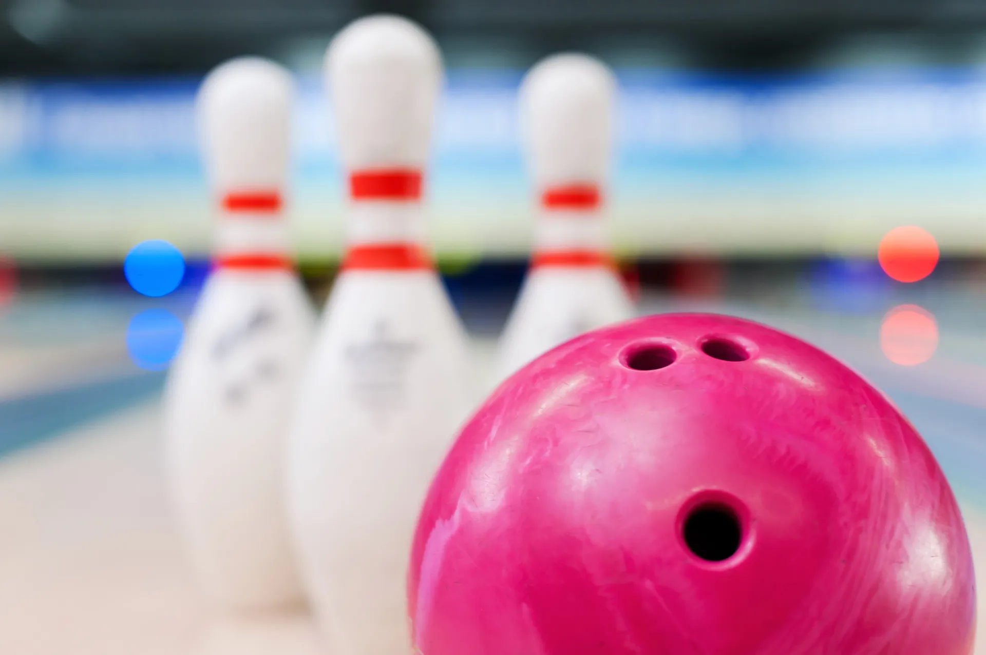 mp10221350 bowling in details close up of red bowling ball lying against pins staying on bowling alley