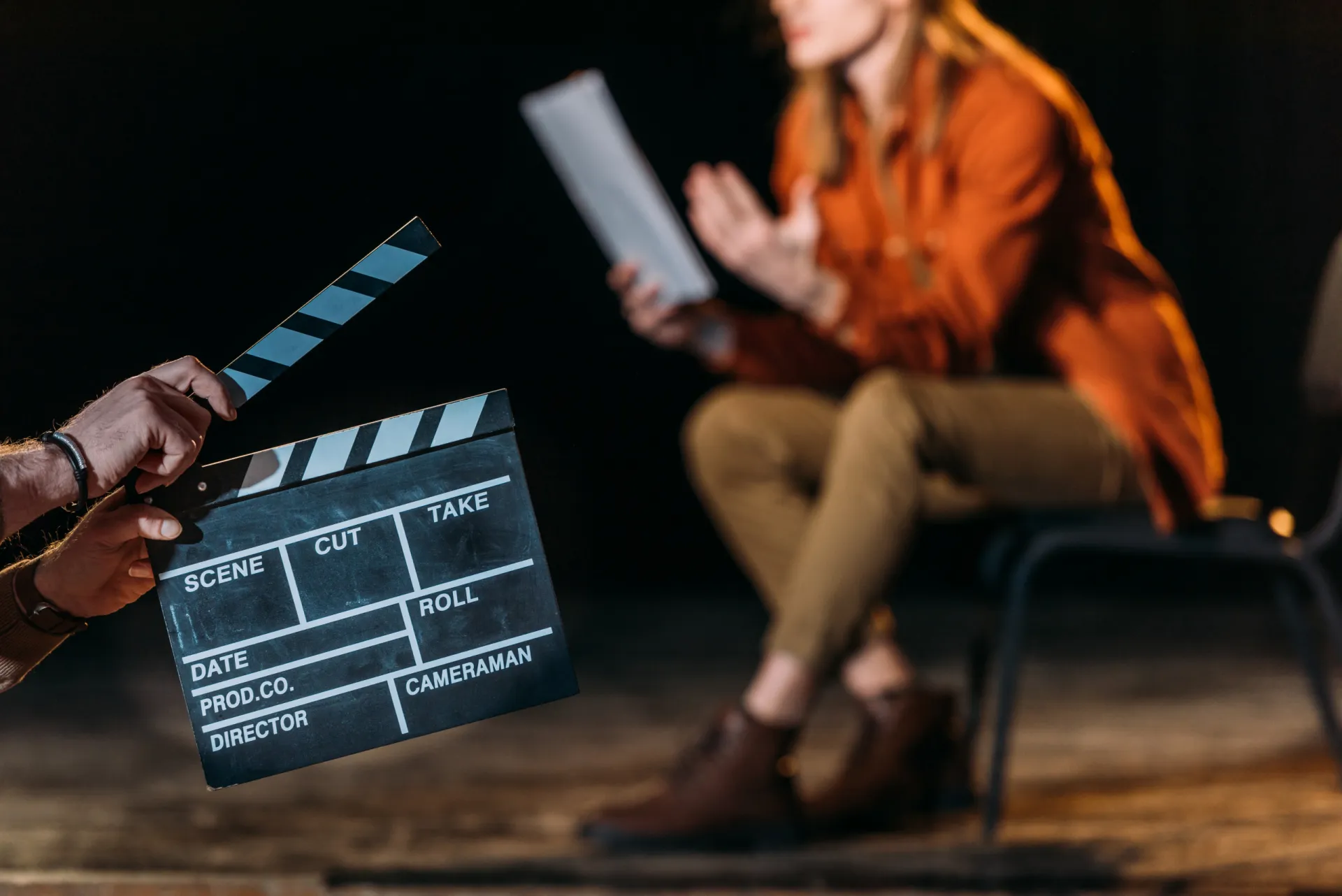 mp36392124 selective focus of actor with clapboard in front