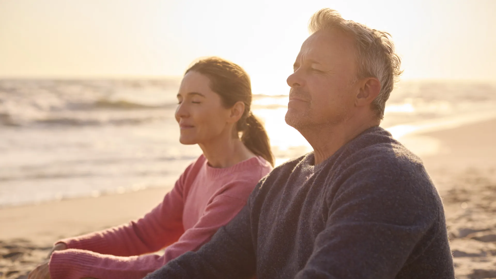 mp64943463 peaceful senior couple relaxing sitting on beach